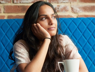Woman sitting with a cup of coffee
