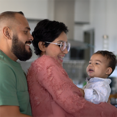 Couple smiling at their baby