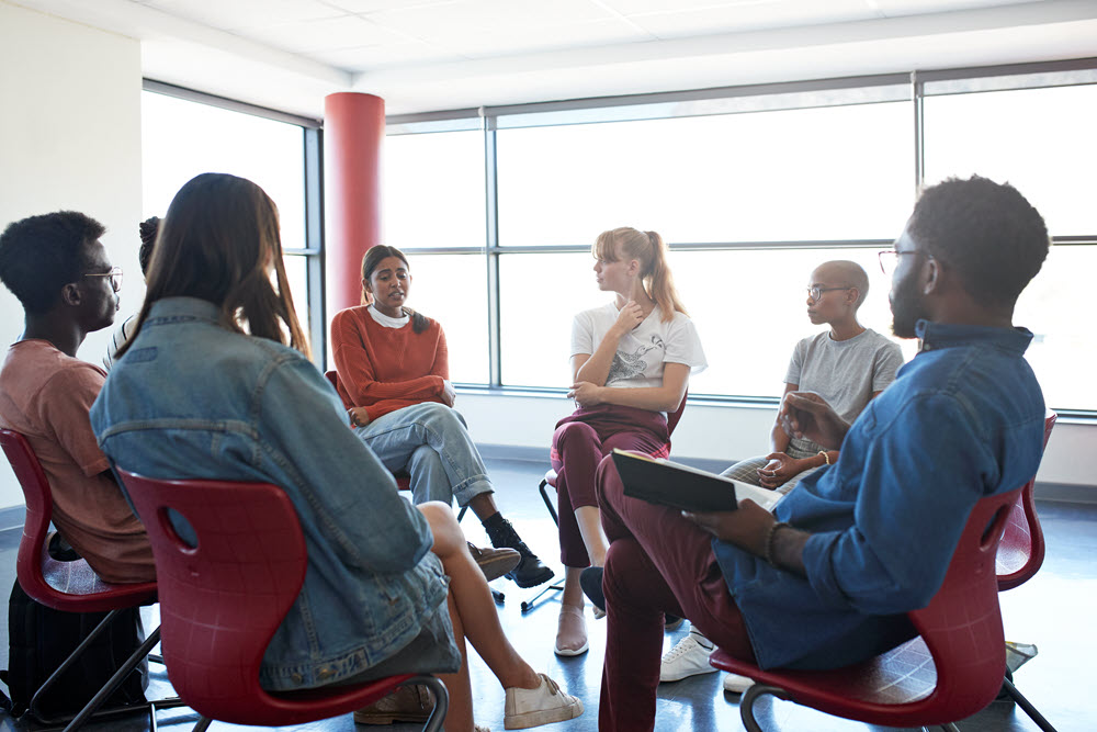 Young people sitting in a circle having a discussion
