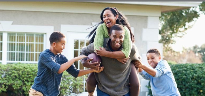 A family playing in a sunny yard