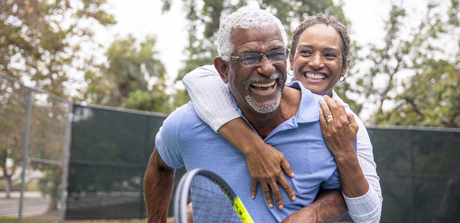 Retiree couple enjoys a game of tennis