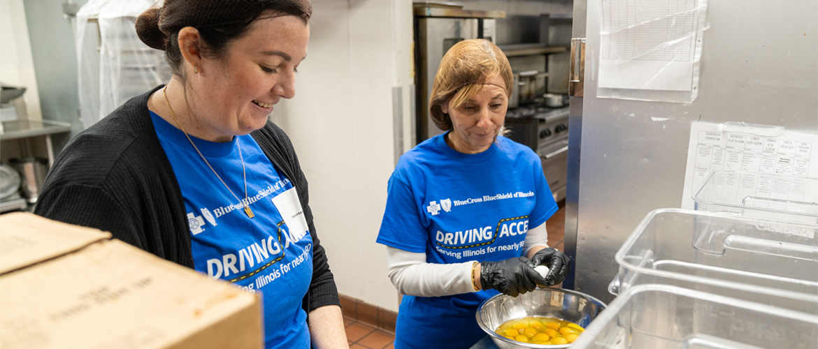 Two women prepare a meal in the kitchen of a community nonprofit