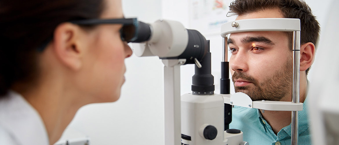 Doctor performs eye exam on patient