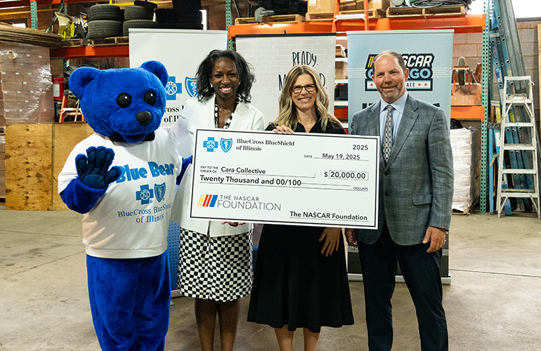 A check presentation to Cara Collective from Blue Cross and Blue Shield of Illinois and NASCAR Chicago Street Race.