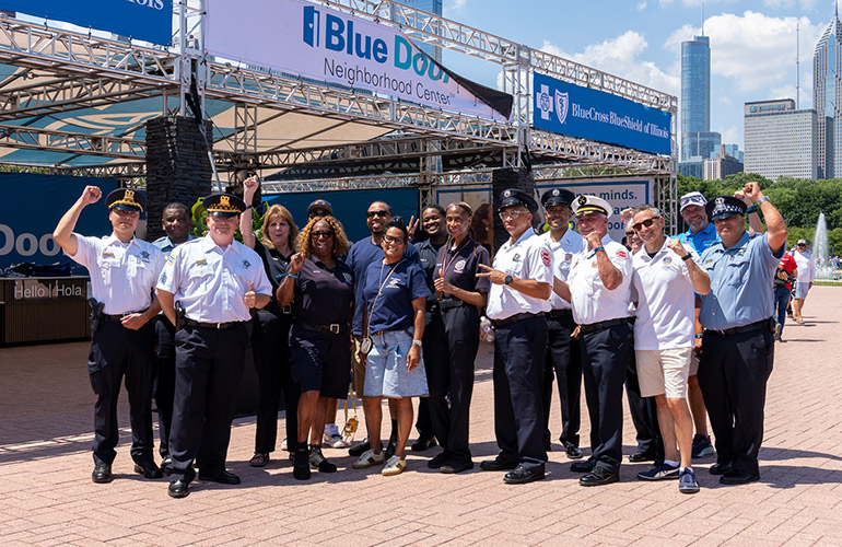 Blue Cross and Blue Shield of Illinois President Brian Snell poses with Hometown Heroes during Chicago's NASCAR weekend