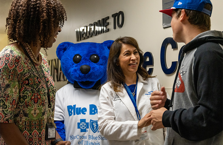 Sinai Chicago leaders and Blue Cross and Blue Shield of Illinois mascot Blue Bear with NASCAR driver Harrison Burton at Mount Sinai Hospital