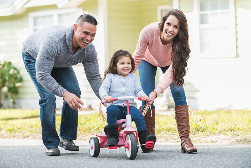 family with child on bike