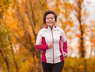 Athletic woman running on a fall day