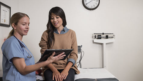 Provider in exam room consulting with patient