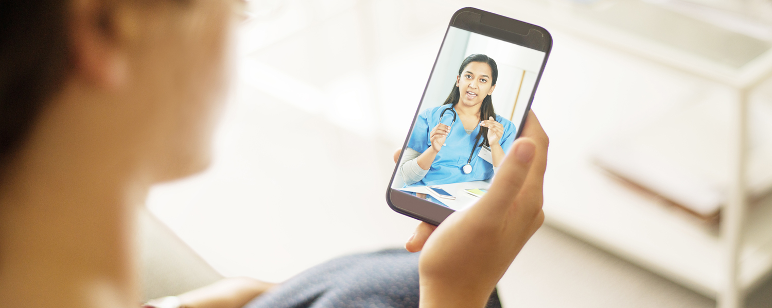 A person meets with a medical professional via video call on their smartphone