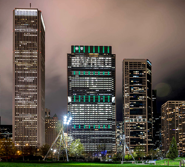 Chicago skyline shows #VaccTogether in BCBSIL building lights