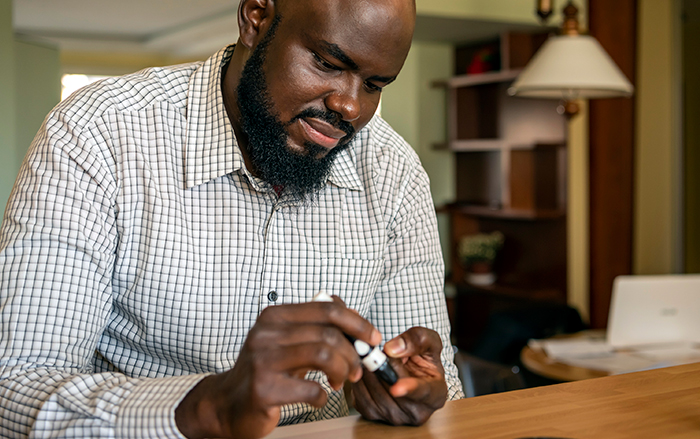 Man checking blood sugar