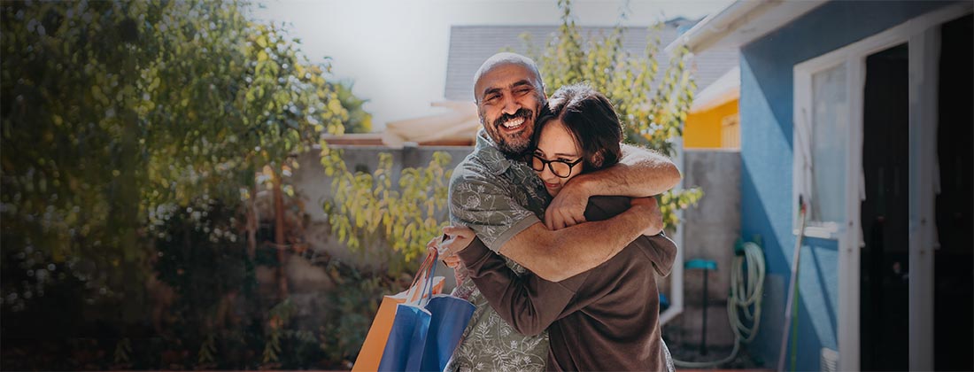 A man and daughter hugging outside