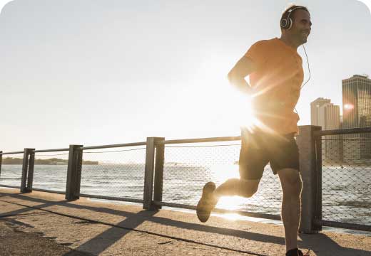 A man running by a lake
